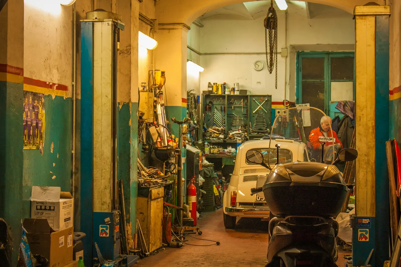 The IRONWHEELMOTORS workshop bays, with a car in for repair